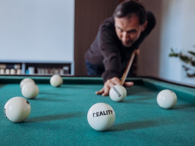 3. Stano Masár_Portrait_Playing with his table game set Existence Game_2020_Photo_Marek Jančúch